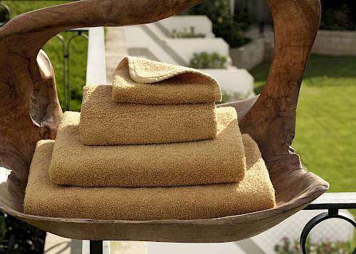 Stack of 'Twill' towels by the Abyss Habidecor brand - beige
