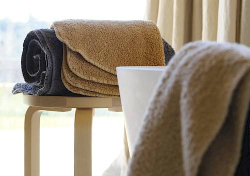 Close-up photo of towels with rounded corners on a stool