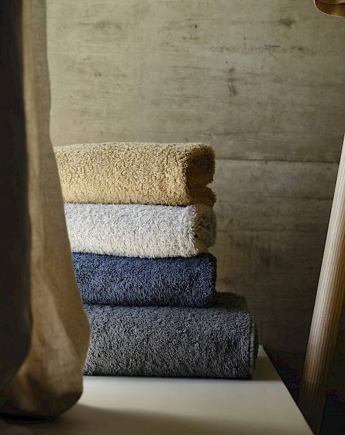 Stack of 'Twill' towels by the Abyss Habidecor brand - blue and beige
