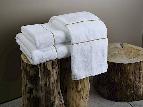 Stack of white bath towels on a tree stump