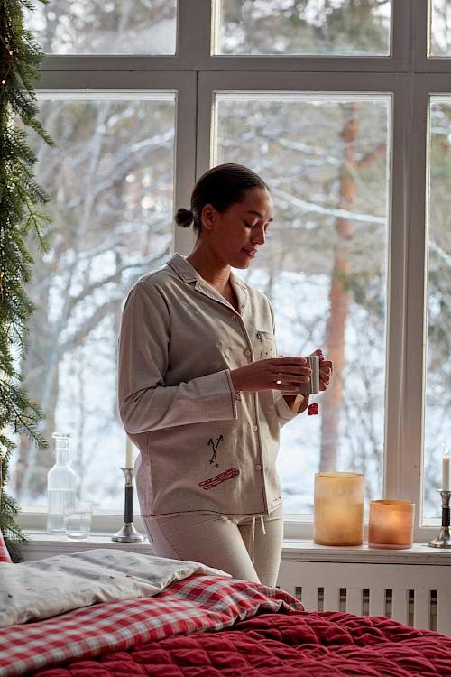 Lifestyle image - woman with tea in a Christmas room